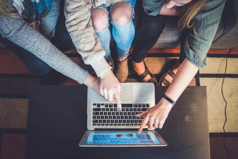 lead generation tools image showing friends looking and pointing at something on a laptop's screen