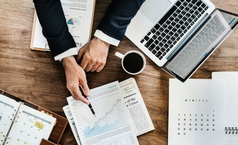 marketing growth strategies image showing an executive pointing to a printed graph with a pen