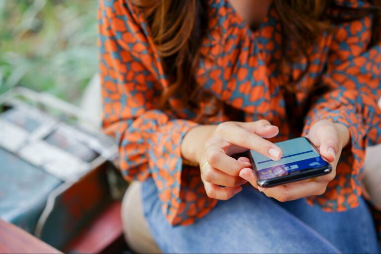 woman engages with a Facebook ad on her phone.