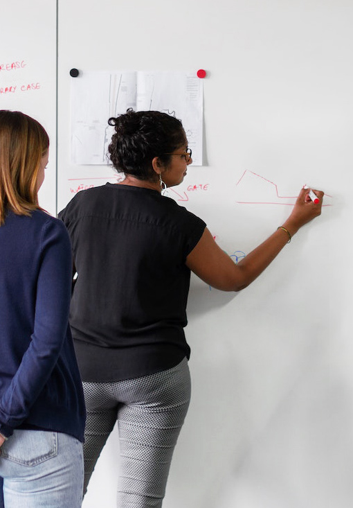 Woman drawing SEO organic traffic results on whiteboard