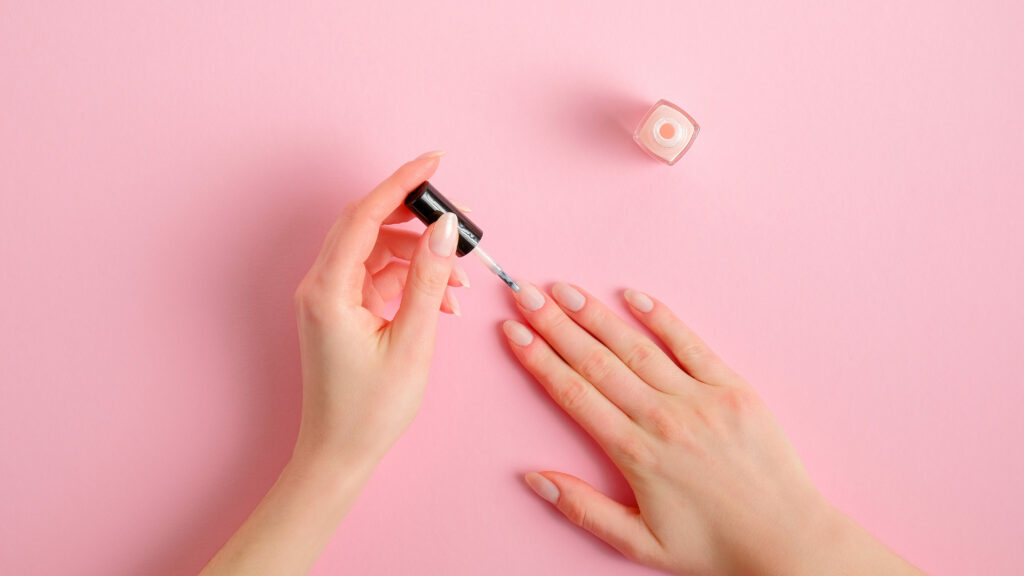woman applying nail polish after seeing a marketing ad