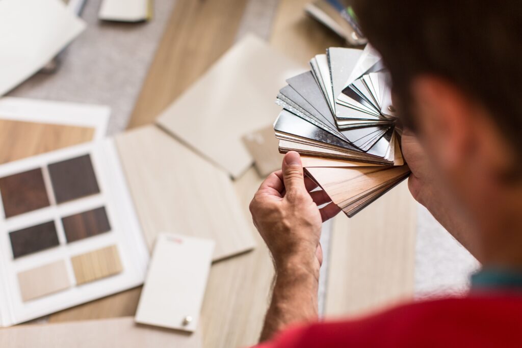 A man looking at flooring samples to decide what to use